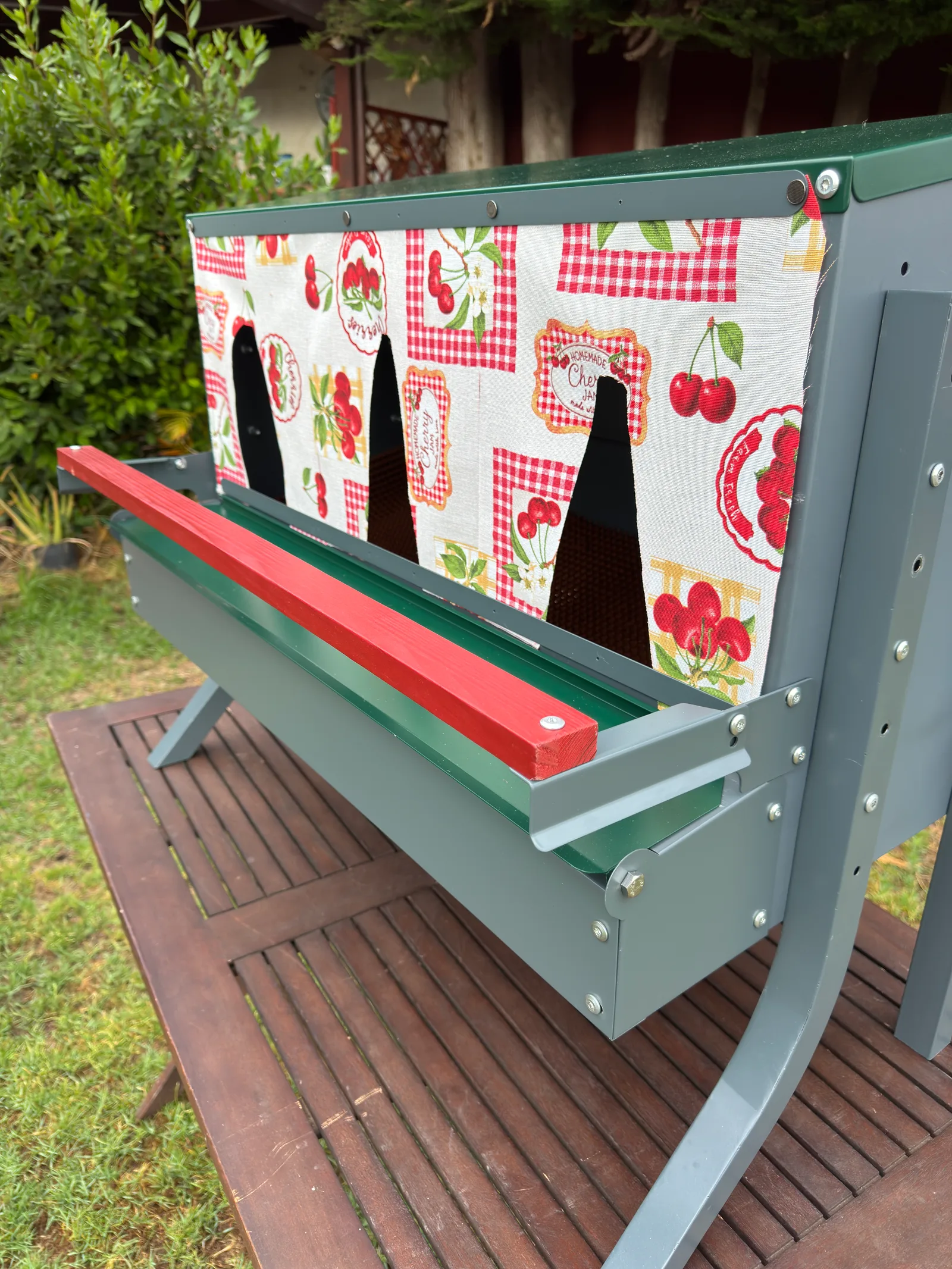 The finished cherry-print curtain installed on the nesting box