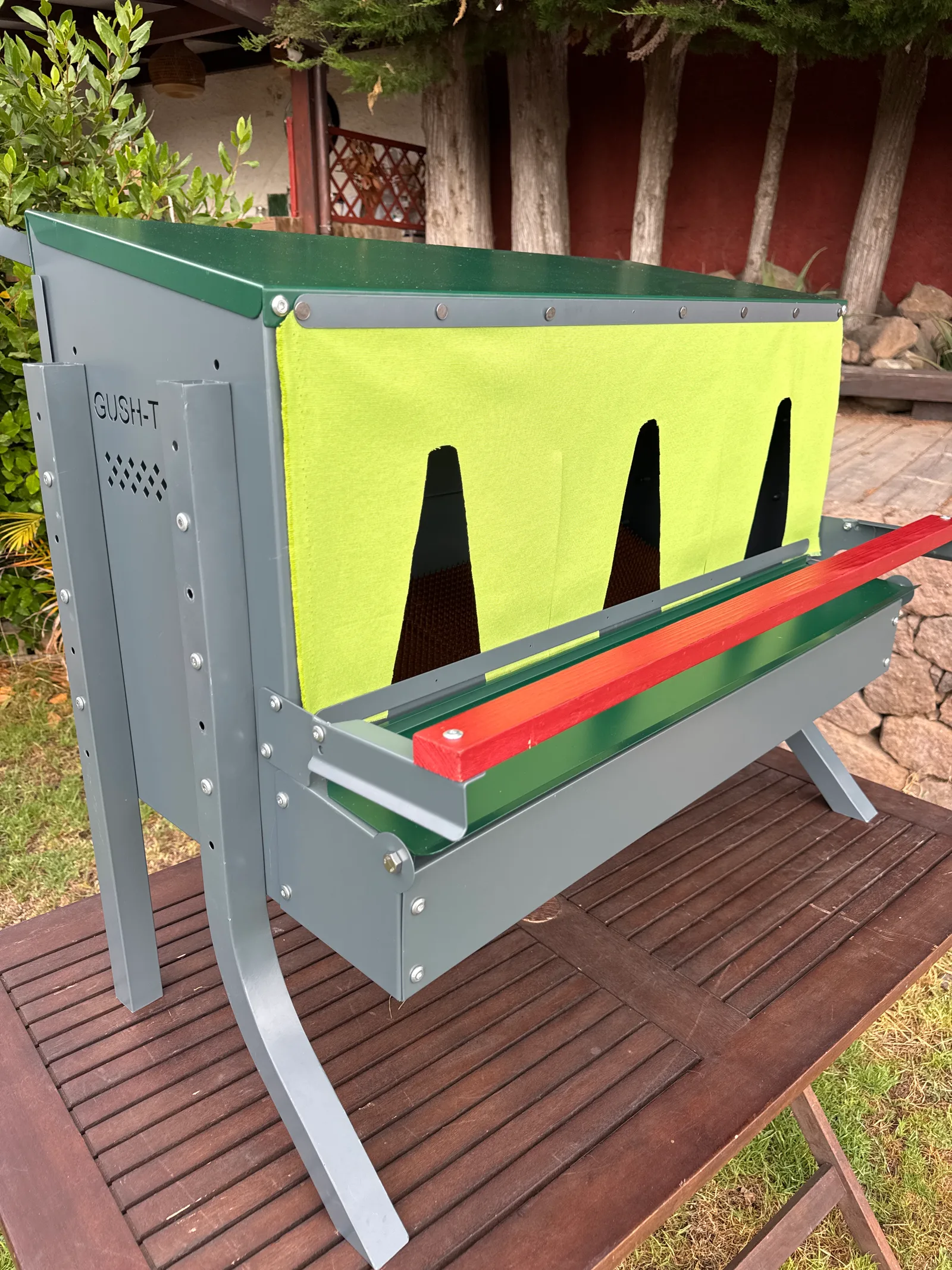 The finished olive fabric curtain installed on the nesting box